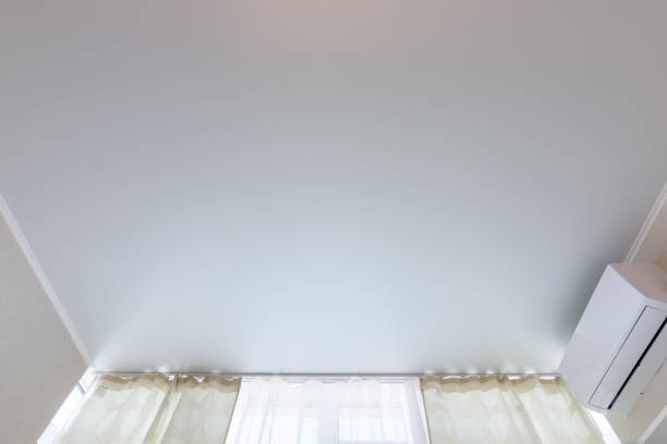 istock Fragment of a classic stretch ceiling above a window in a room 1236223191