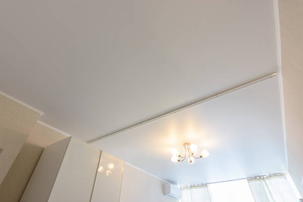 istock Classic white matte stretch ceiling with separation for curtains in two halves 1236223198
