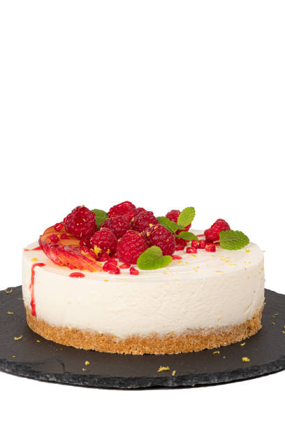 istock Cheesecake with raspberriees, plum and mint leaves isolated on white background 1236242733