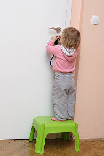 istock Little girl unlocking the door 123624726