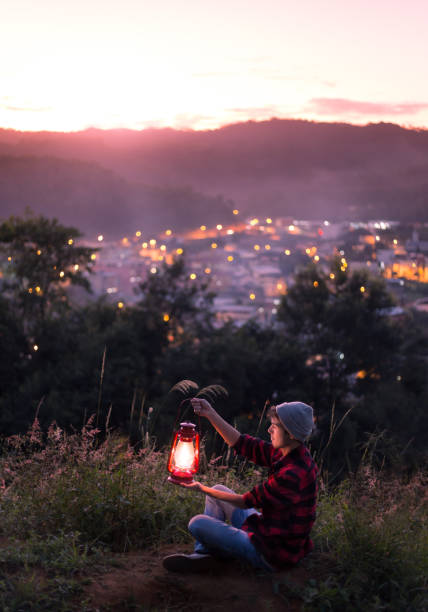 istock Young man with a lit kerosene lamp 1236248426