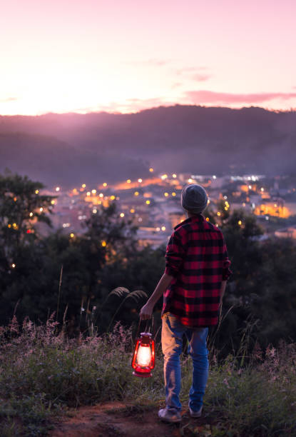 istock Young man with a lit kerosene lamp 1236248440