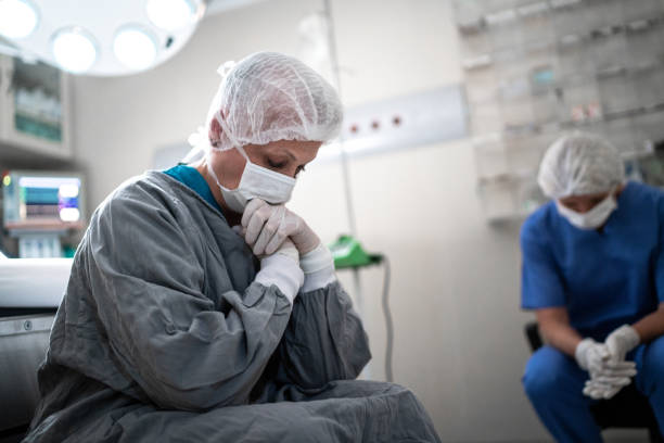 Worried healthcare coworkers at operating room in hospital Worried healthcare coworkers at operating room in hospital oops stock pictures, royalty-free photos & images