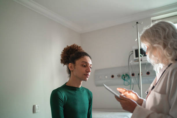 doctor talking to patient at hospital room with digital tablet - transgender imagens e fotografias de stock