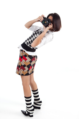 Young woman taking a photograph.
