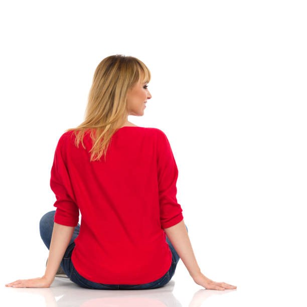 istock Young Woman In Red Sweater Is Sitting On A Floor. Rear View. 1236472780