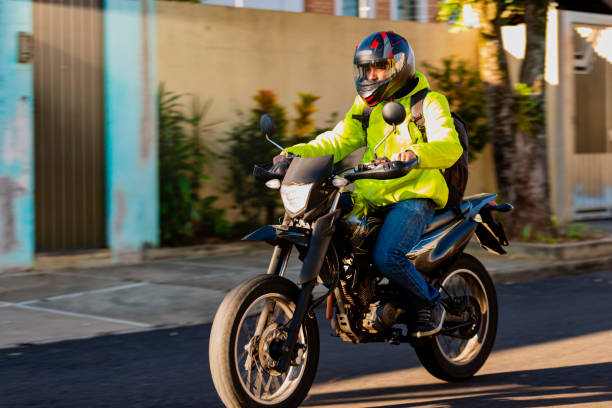 Delivery man driving to his destination to deliver Delivery man driving to his destination to deliver. biker photos stock pictures, royalty-free photos & images