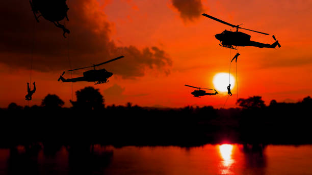 istock soldier silhouette climb down from helicopter on sunset Concept stop warfare with copy space add text 1236690693