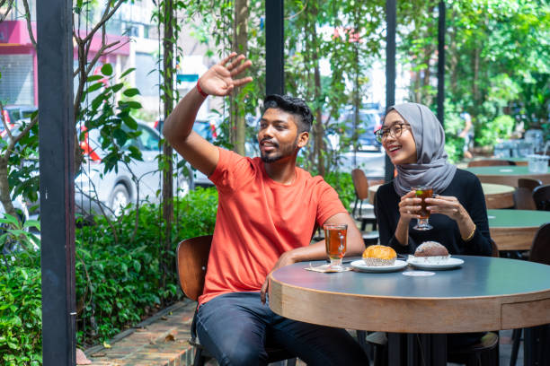 istock Young Malaysian enjoys outdoor coffee date 1236741950