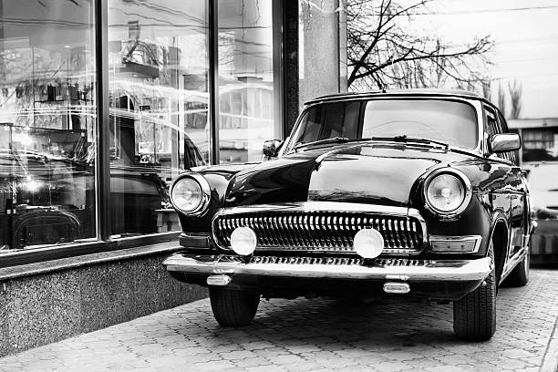 istock Retro car next to a storefront in black and white 123674305