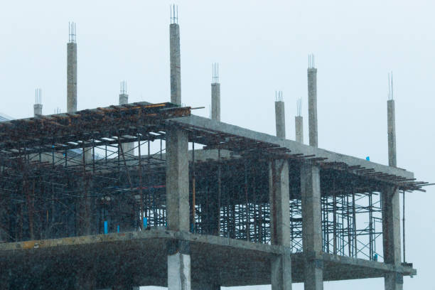 Heavy rain fall in a construction site. Focus on the orange color cone.