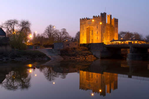 Bunratty castle at dusk with reflection in the river - Ireland