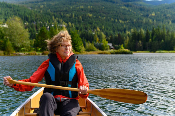 istock Active senior woman canoeing on vacation 1236774353