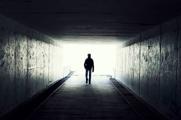 Light at End of Tunnel silhouette in a tunnel. Light at End of Tunnel light at the end of the tunnel photos stock pictures, royalty-free photos & images