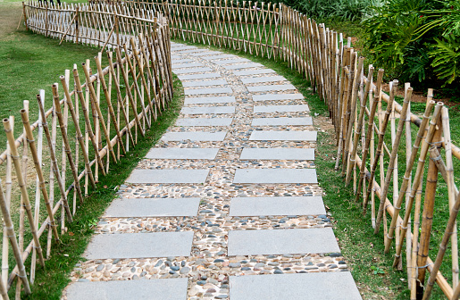 Stone path with bamboo fence in the park.