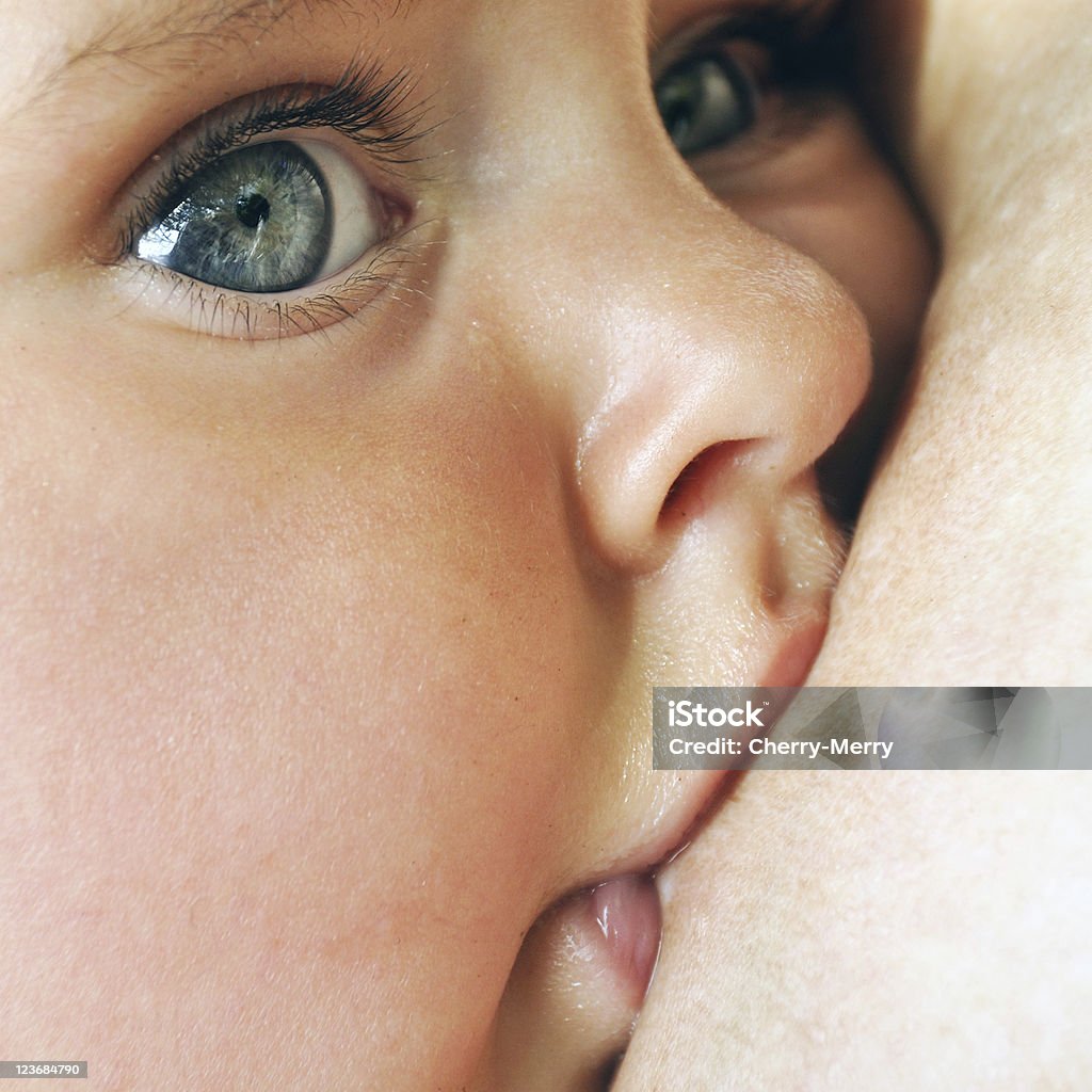 Close up of baby breastfeeding baby eating mother's breast milk Baby - Human Age Stock Photo