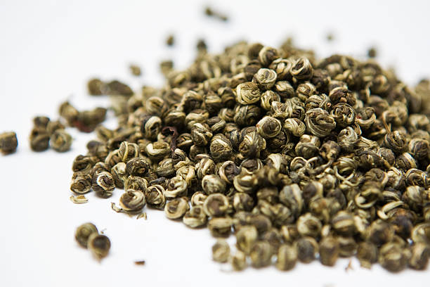 Green tea leaves on a white background stock photo