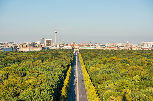 Panoramic city view of Berlin, viewfrom the top of the Berlin Victory Column in Tiergarten, Berlin, with modern skylines and green forest.