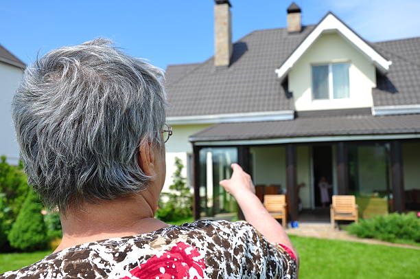 istock woman pointing a house 123689756