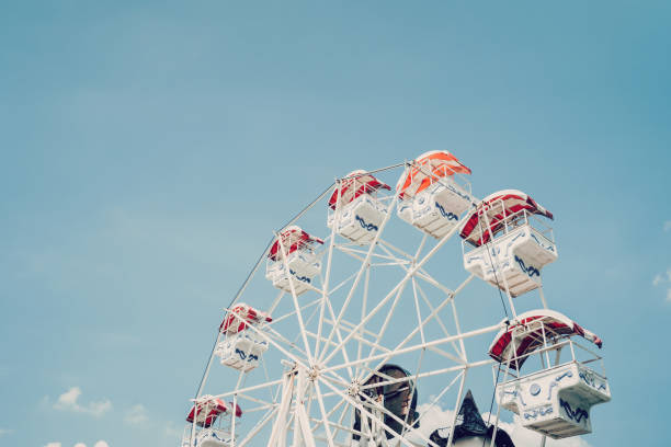 istock Ferris wheel on cloudy sky background with vintage toned. 1236930559