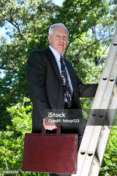 Mature Man In Business Suit Climbing Ladder Stock Photo - Download Image Now - Achievement, Active Lifestyle, Active Seniors