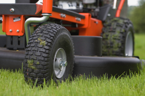 A large mower sits on the lawn.