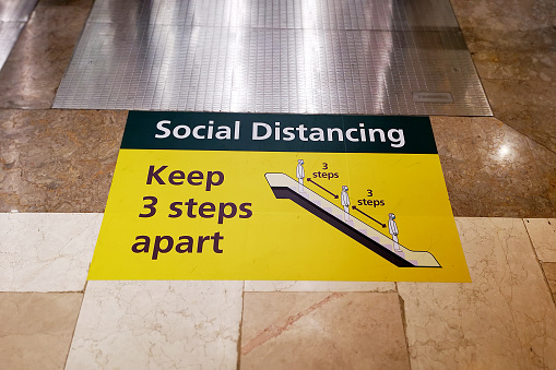 A visibly floor sticker disseminate information, emphasising social distancing 3 steps apart when using escalator in Malaysia.