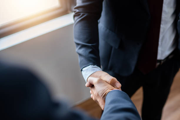 istock successful contract negotiate and handshake concept, two businessman shake hand with partner to celebration partnership, teamwork, business deal in room meeting after success communication, agreement 1236959172