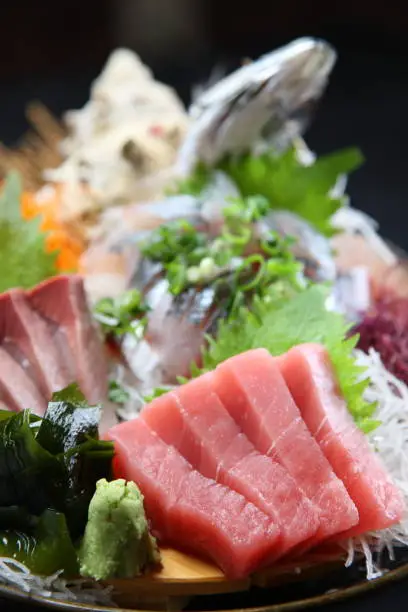 seasonal fresh sashimi assorted plate on dark background