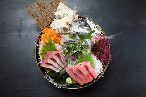 seasonal fresh sashimi assorted plate on dark background