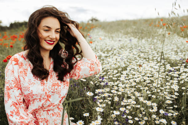 istock Young female beauty in the white fields of chamomile 1237104896
