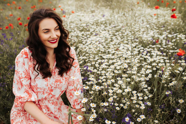istock Young female beauty in the white fields of chamomile 1237105411