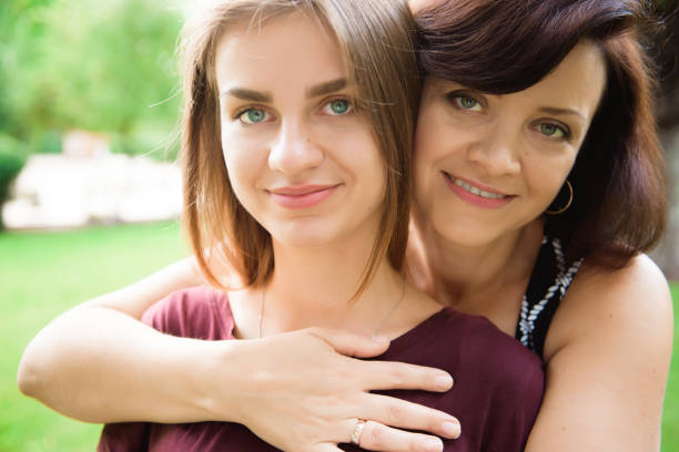 istock Cute young daughter embracing her mother with love. 1237105920
