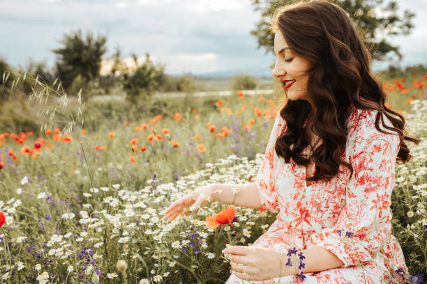 istock Young female beauty in the white fields of chamomile 1237106489