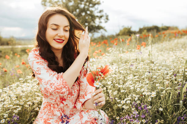 istock Young female beauty in the white fields of chamomile 1237106501
