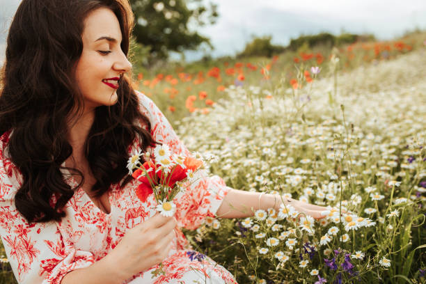 istock Young female beauty in the white fields of chamomile 1237107649