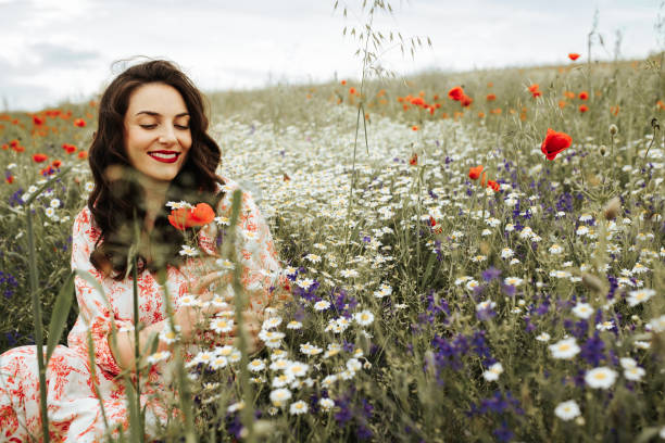 istock Young female beauty in the white fields of chamomile 1237107709