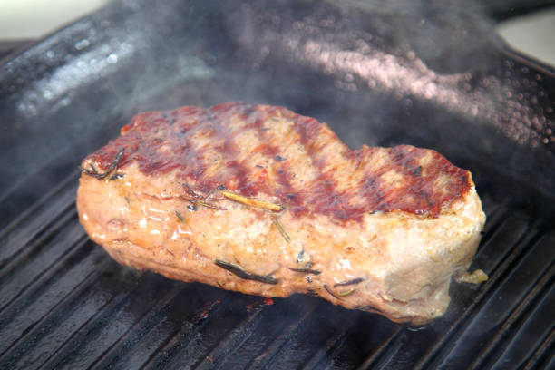 istock Grilling steak on a grill pan. Chef making steak. Beef tender steak on the grill pan. Meat for steak. 1237107721