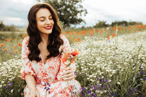 istock Young female beauty in the white fields of chamomile 1237108254