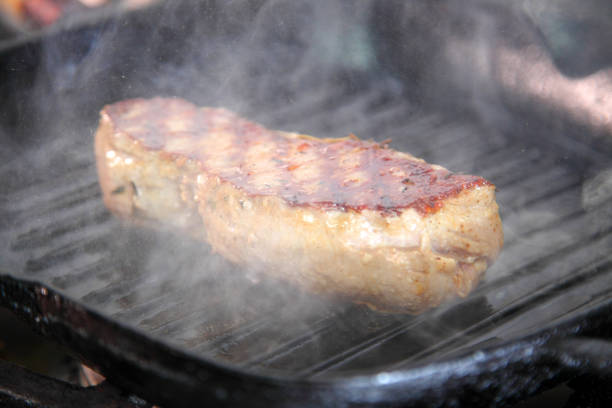 istock Grilling steak on a grill pan. Chef making steak. Beef tender steak on the grill pan. Meat for steak. 1237108256