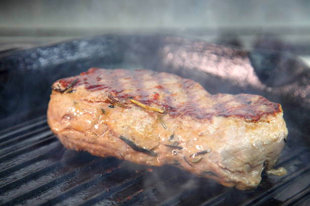istock Grilling steak on a grill pan. Chef making steak. Beef tender steak on the grill pan. Meat for steak. 1237109370