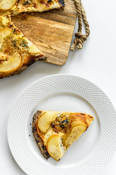 istock Homemade pizza with pears, nuts and blue cheese. White background. Top view 1237110528