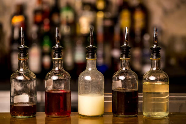 istock Bottles filled with syrups for mixing cocktails on bar counter. Alcohol drinks ingredients. Professional cocktail liquors. 1237113790