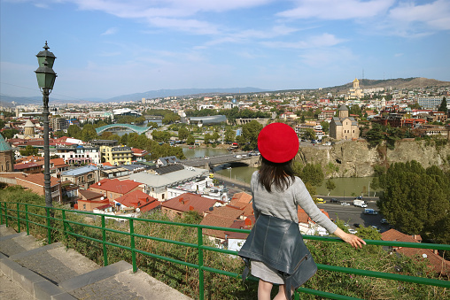 Female Traveler Impressed by the Panoramic Aerial View with Many of Iconic Landmarks of Tbilisi, the Capital City of Georgia, ( Self Portrait )