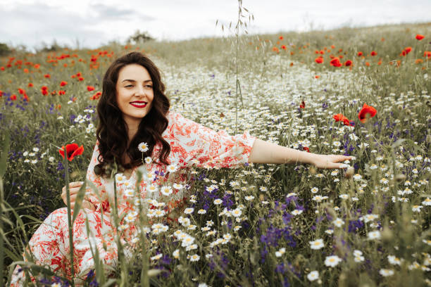 istock Young female beauty in the white fields of chamomile 1237120419