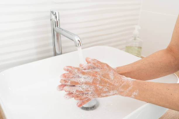 istock Woman washing her hands in bathroom 1237129264