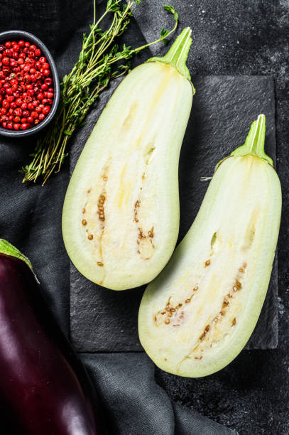 istock Sliced eggplant. Raw organic vegetables. Black background. Top view. 1237139962