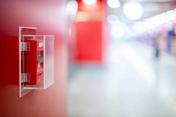 The red fire alarm switch on the red wall at the Bangkok subway.