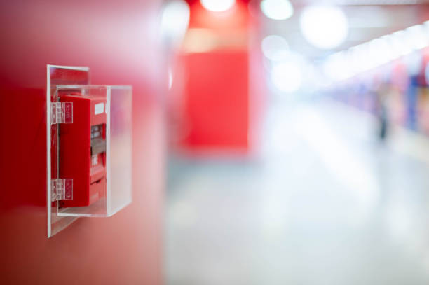 The red fire alarm switch on the red wall at the Bangkok subway. stock photo
