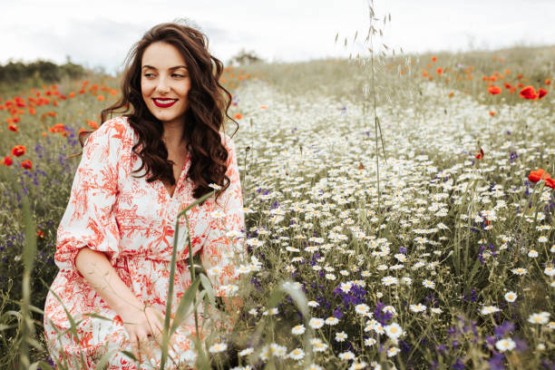 istock Young female beauty in the white fields of chamomile 1237145294